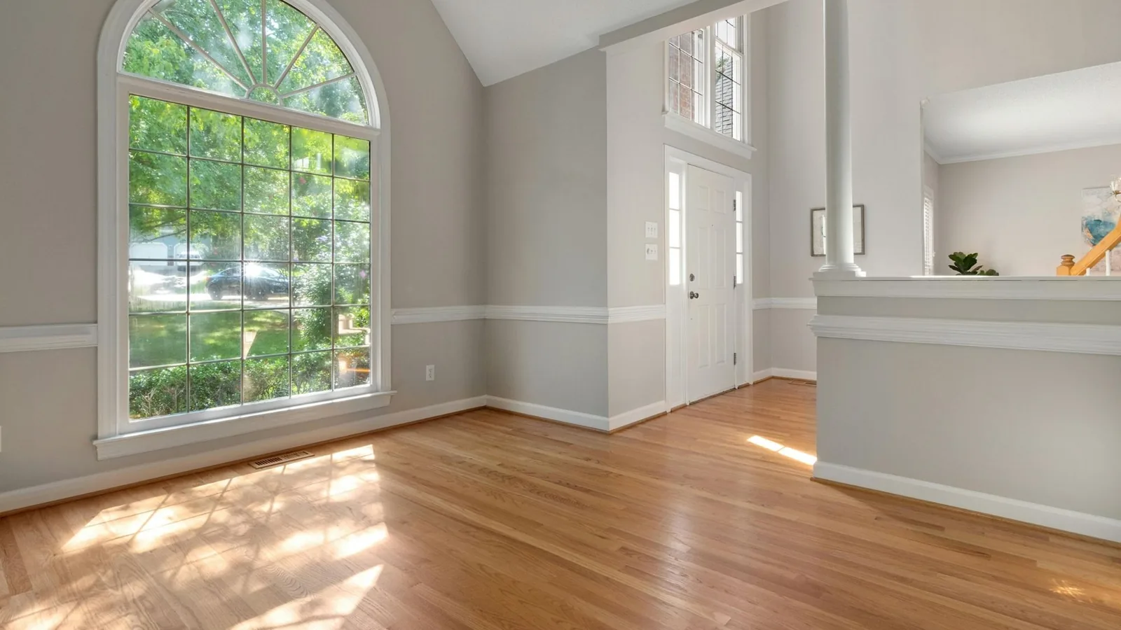 Bright cleaned living area with large arched window