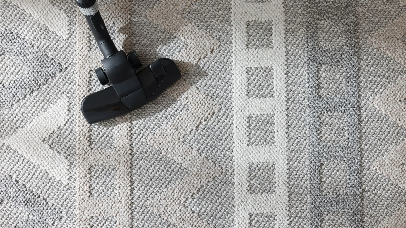 Vacuum head cleaning a textured area rug